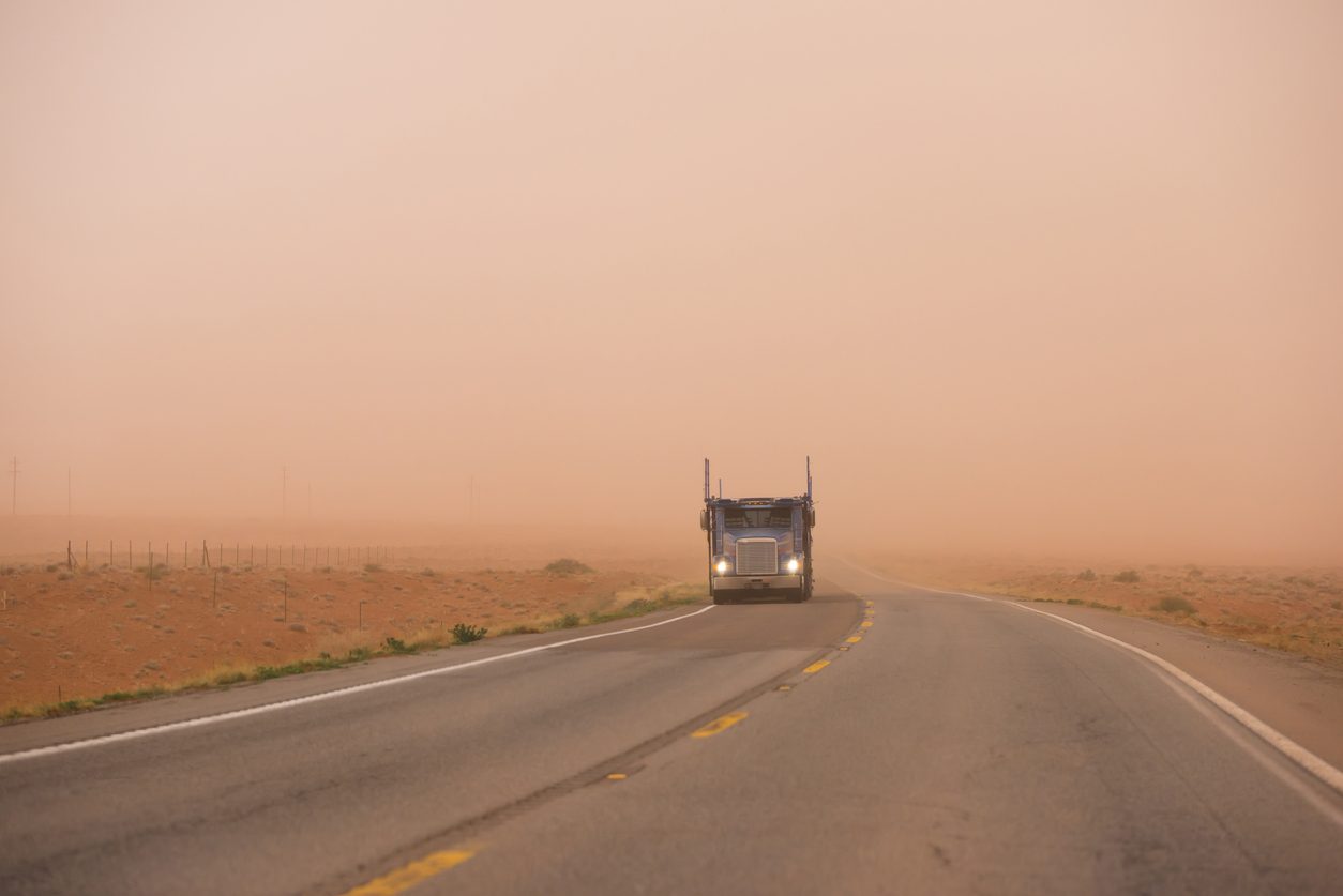 Car hauler on an Arizona highway during a dust storm