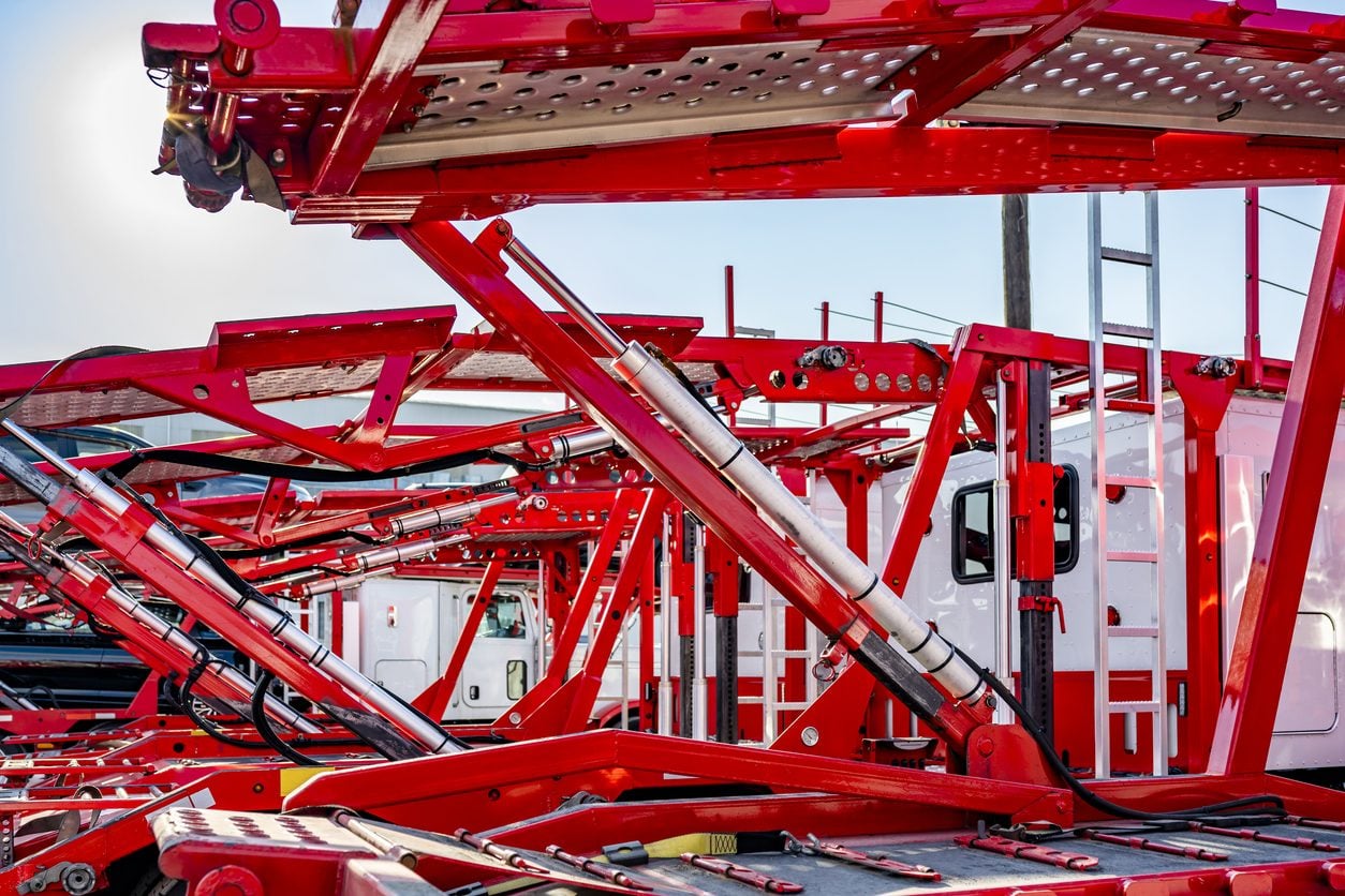 Hydraulic decks of an empty car carrier trailer