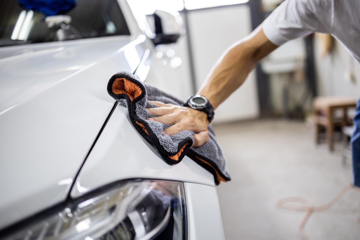 Polishing a car body panel in a workshop