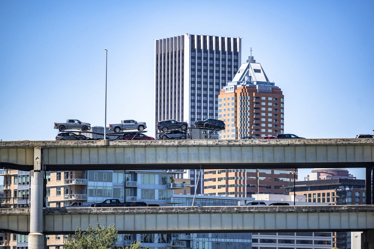 Car hauler on an elevated city roadway