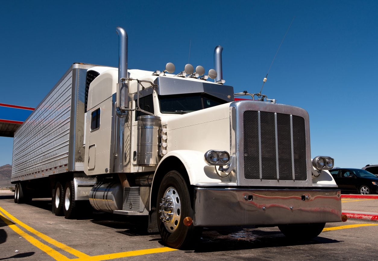 Classic conventional tractor parked at a truck stop