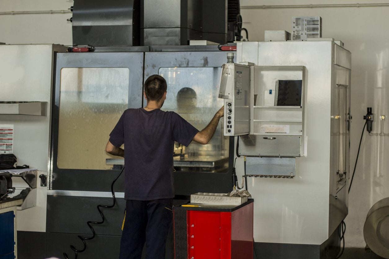 Operator working a CNC milling machine in a workshop