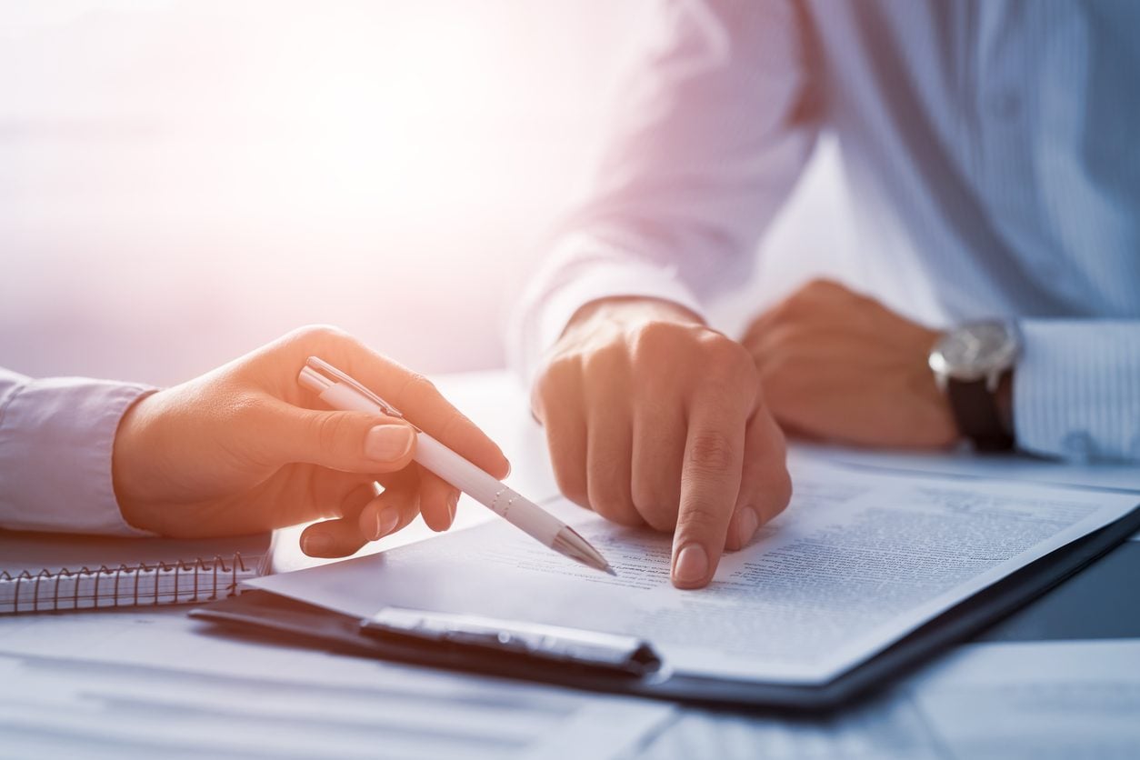 Completing the paperwork for a vehicle title transfer