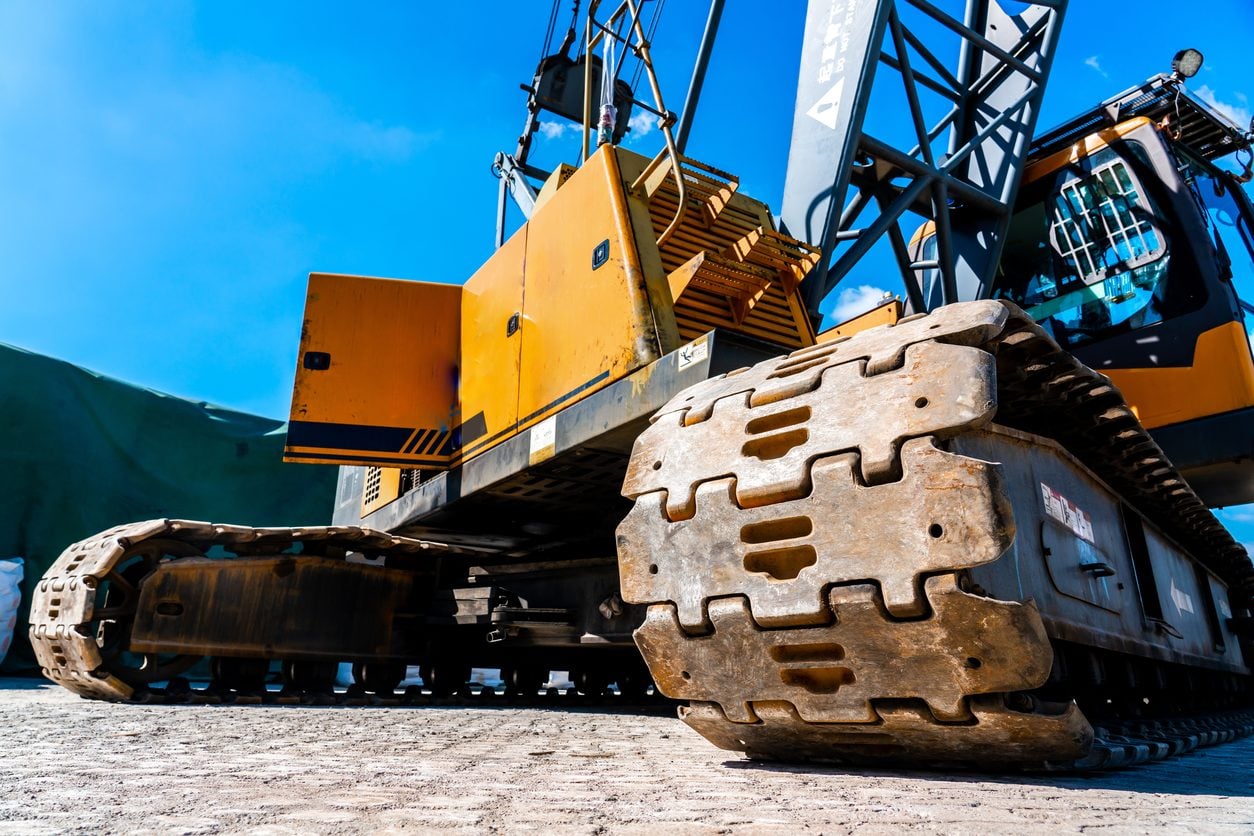 Steel tracks of a crawler machine at a construction site
