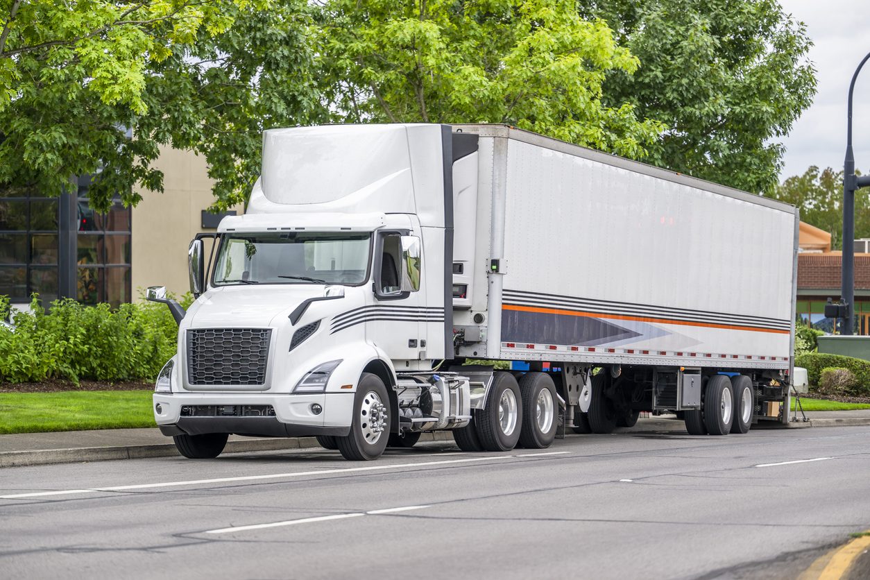 Day cab tractor and trailer stopped on a city street