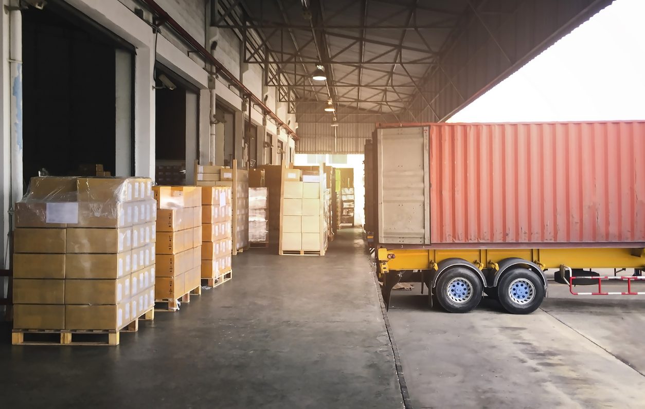 Trailer at a warehouse dock with pallets ready to load