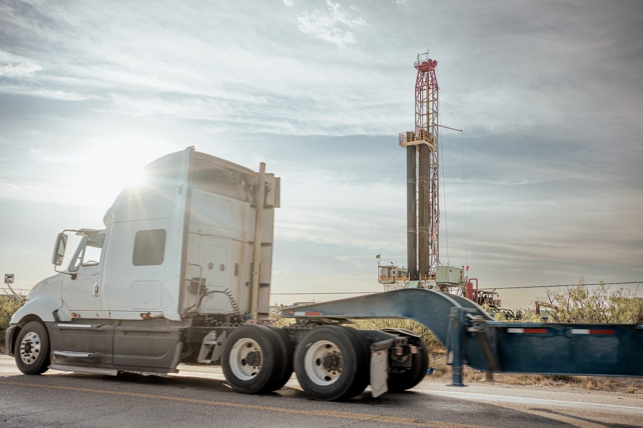 Drilling rig and a tractor unit at an oil and gas site