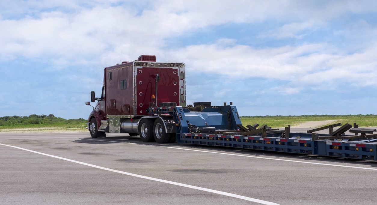Conventional tractor with an empty multi axle lowboy