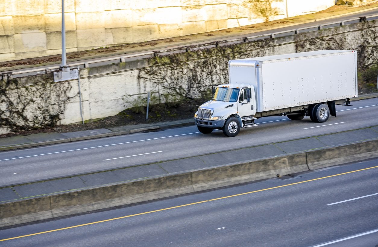 Enclosed box truck running a divided highway