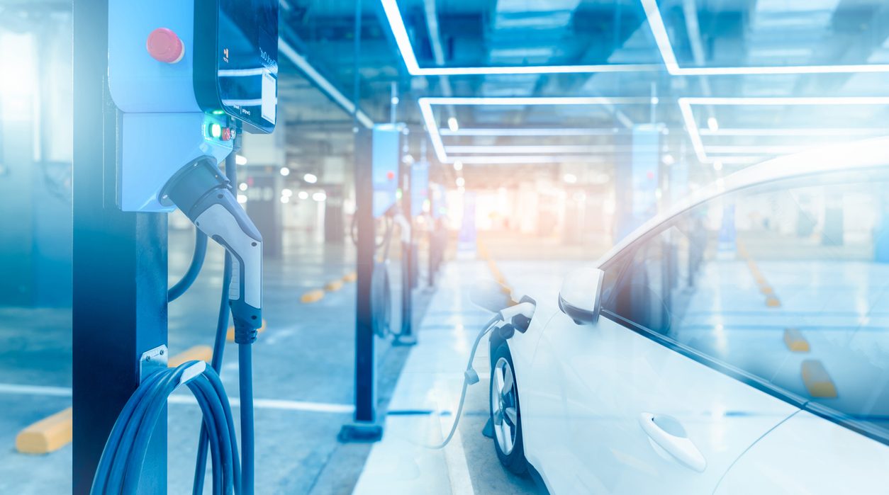 Electric vehicle charging bays in a parking structure
