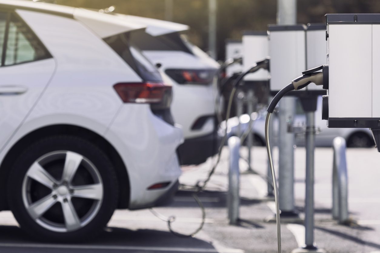 Electric car charging at a parking lot charge point