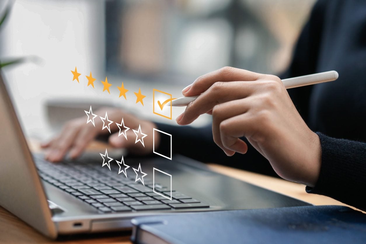 Selecting a five star rating on a laptop