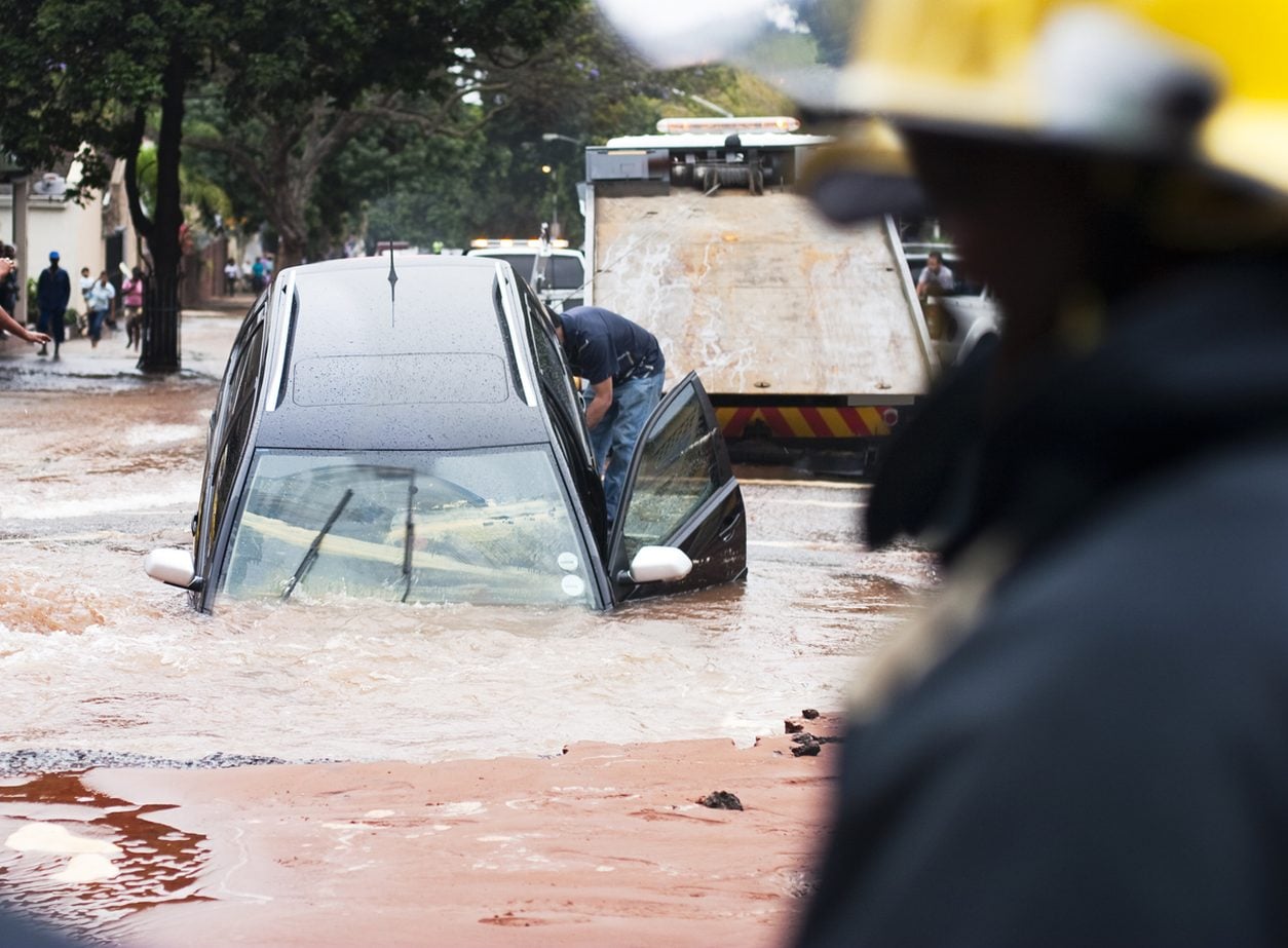 Vehicle being recovered from floodwater by a tow truck