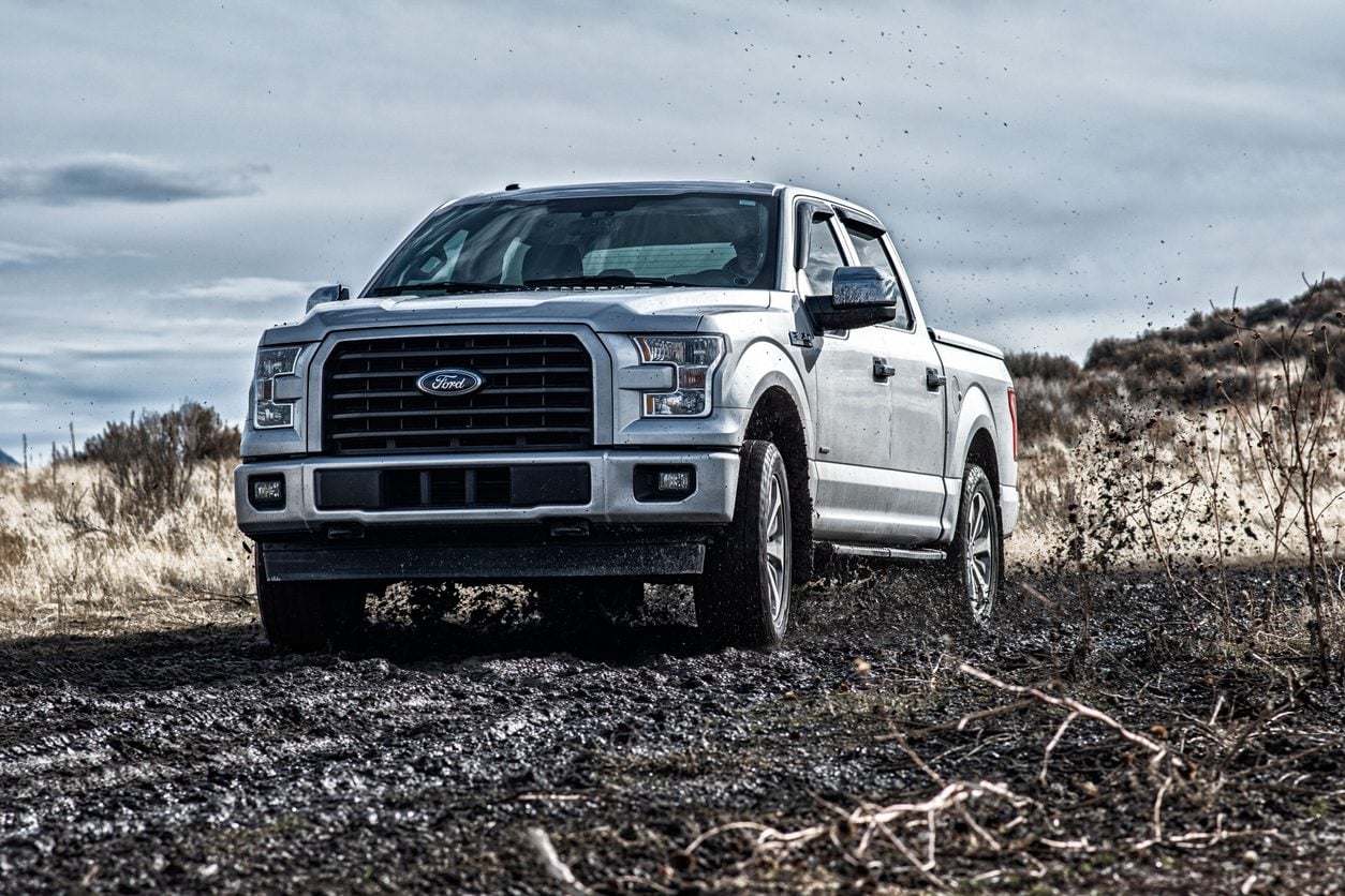 Silver Ford F-150 driving on rough ground