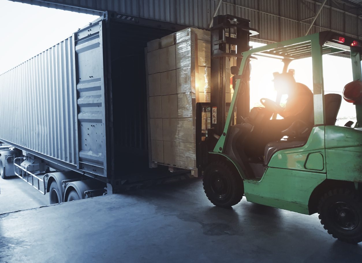 Forklift loading a pallet into a trailer