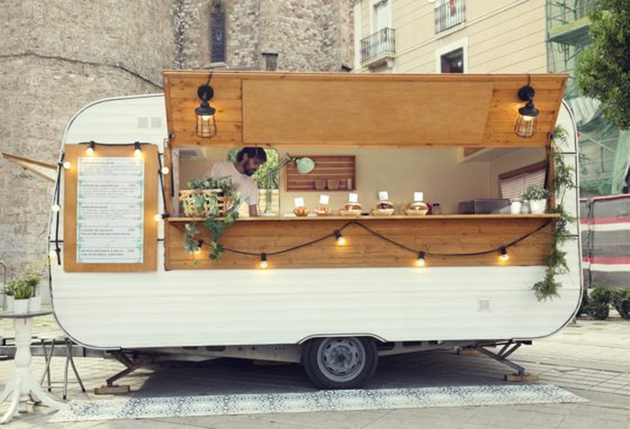 Vintage food trailer with open service window on a city street