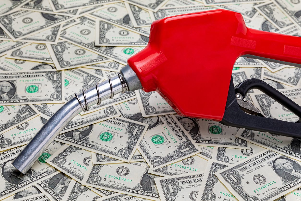 Fuel nozzle resting on US banknotes