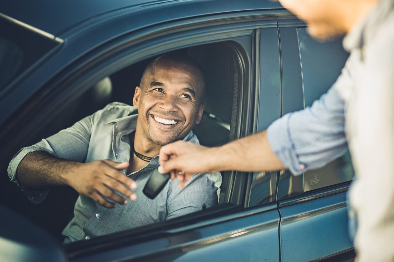 Handing over car keys to the new owner