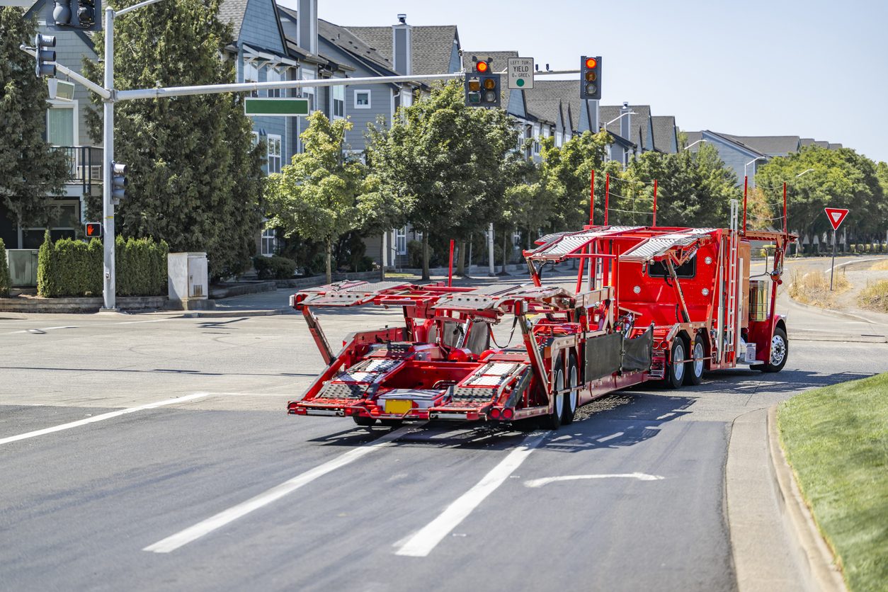 Car hauler turning through a city intersection