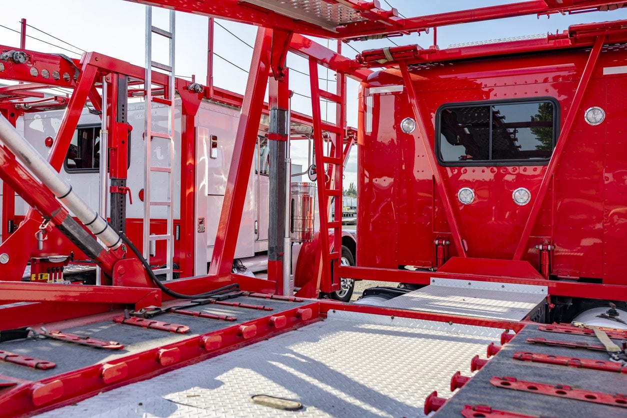 Empty car hauler deck showing ramps and deck plates