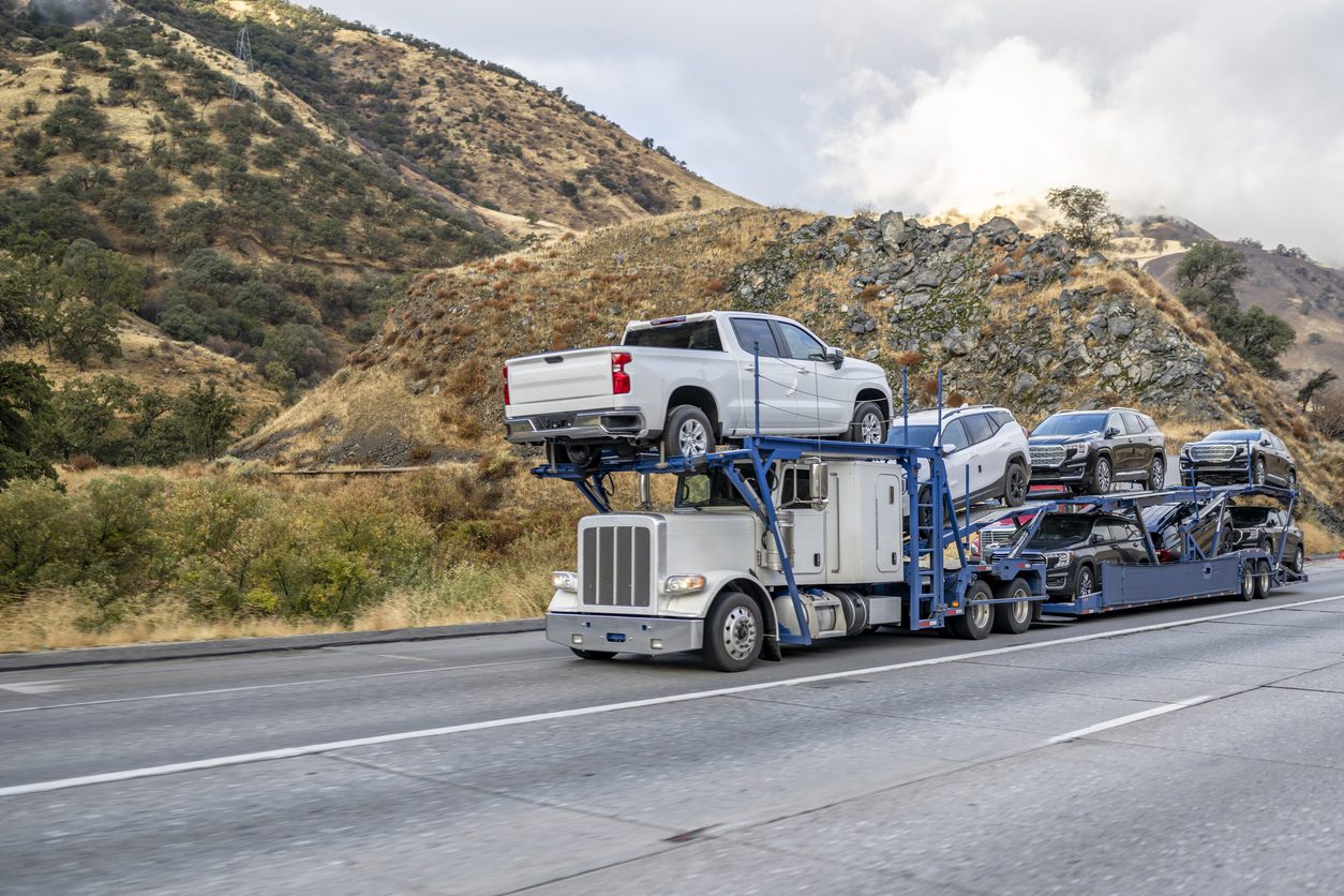 Loaded car hauler climbing a mountain highway