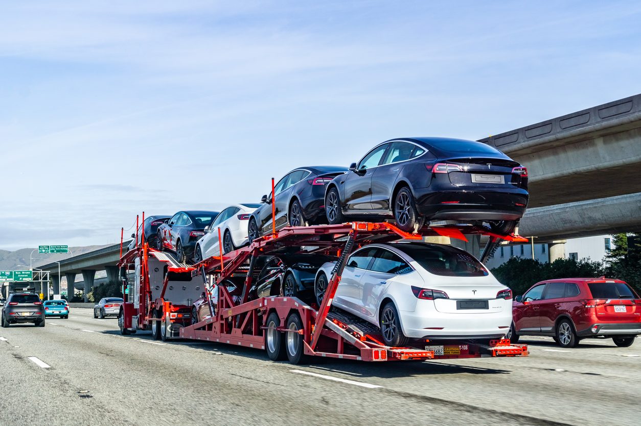 Loaded car hauler traveling a multilane freeway