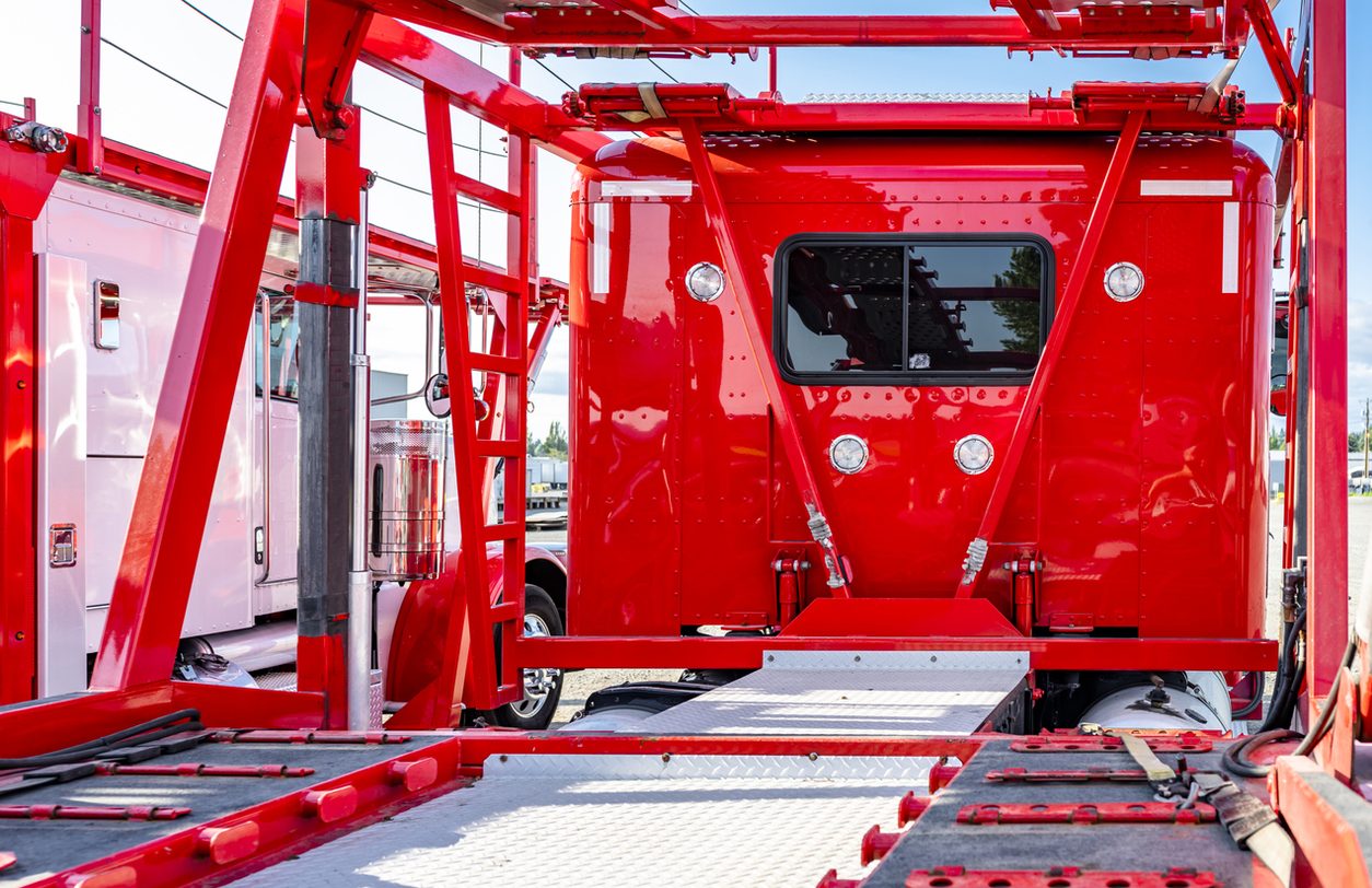 Classic vehicles secured on an enclosed style deck