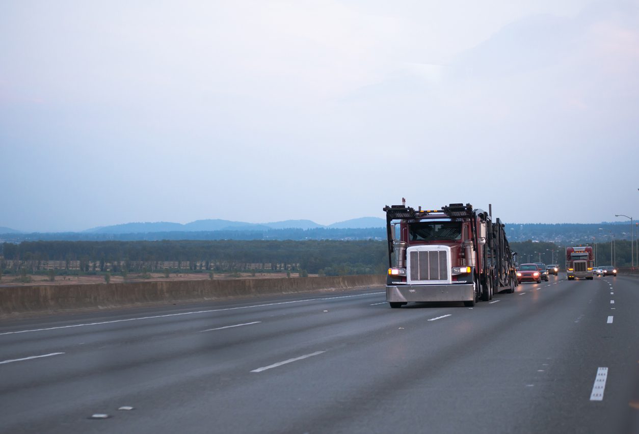 Car hauler passing traffic on an open highway