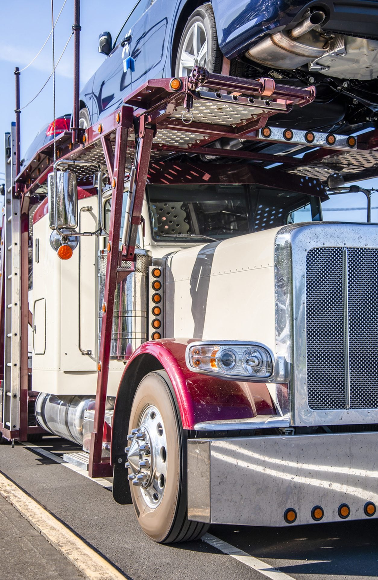 Classic conventional car hauler with vehicles on its upper deck