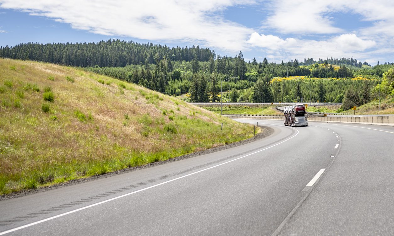 Car hauler climbing a grade on an interstate highway