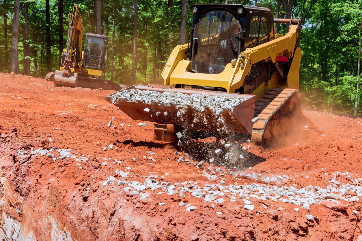 Tracked machine working broken stone