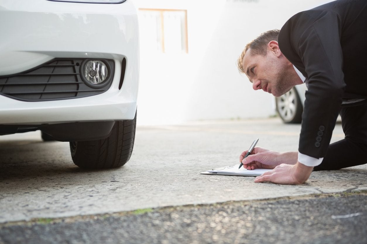 Inspecting a car and recording it on a clipboard