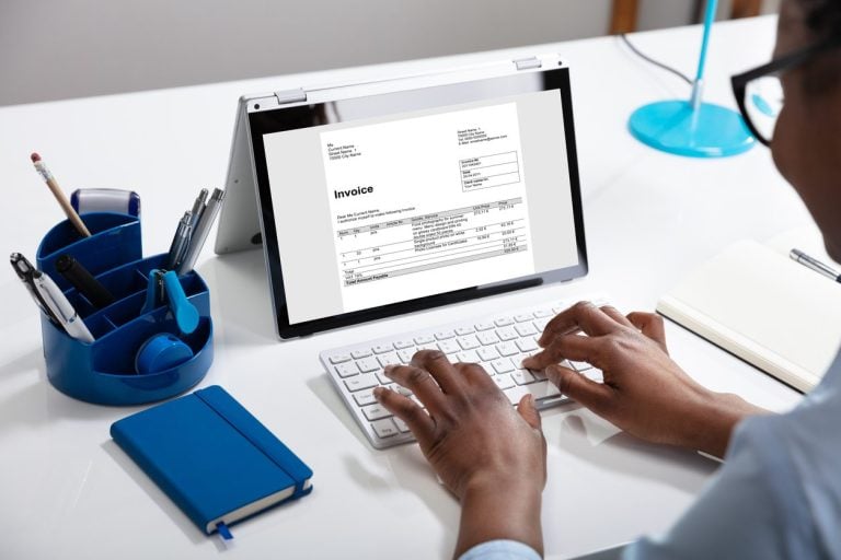 Preparing an invoice on a laptop
