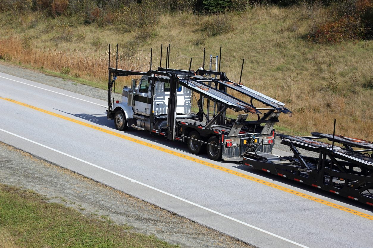Empty car carrier trailer traveling along a highway
