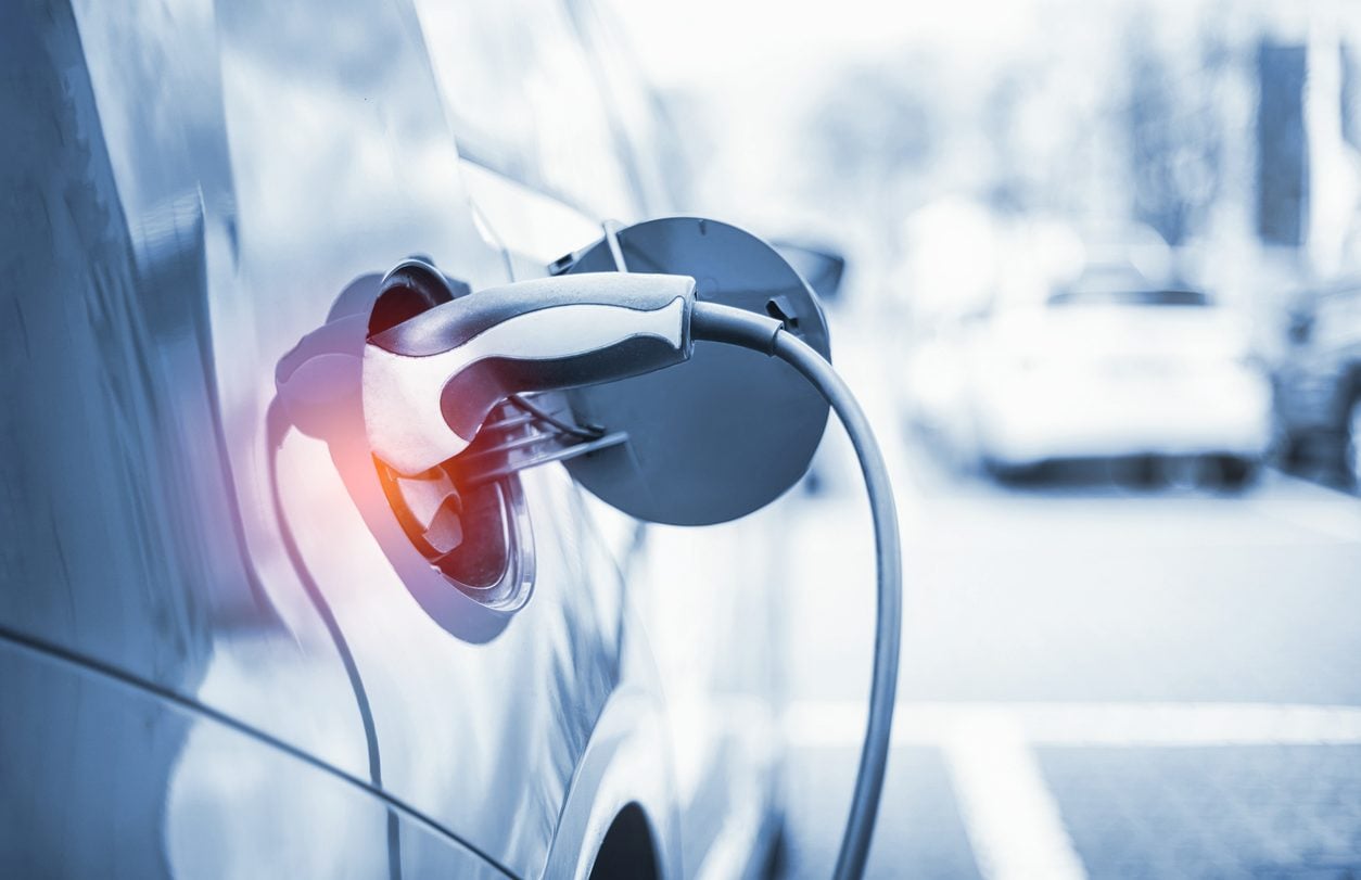 Charging connector plugged into an electric vehicle