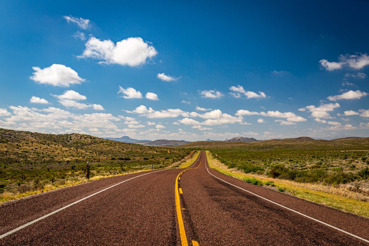Two lane US highway running through open Texas country