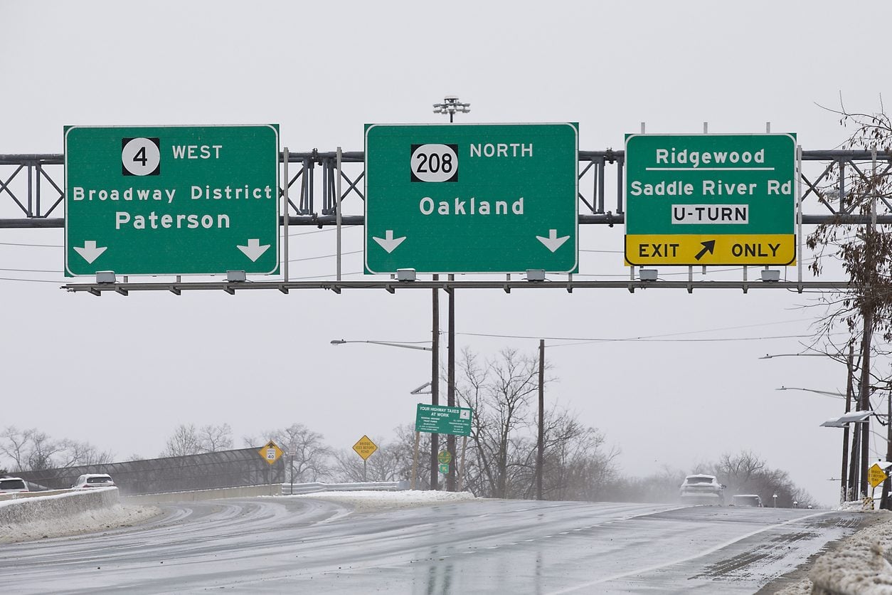 Highway signs and traffic on a snow covered interstate