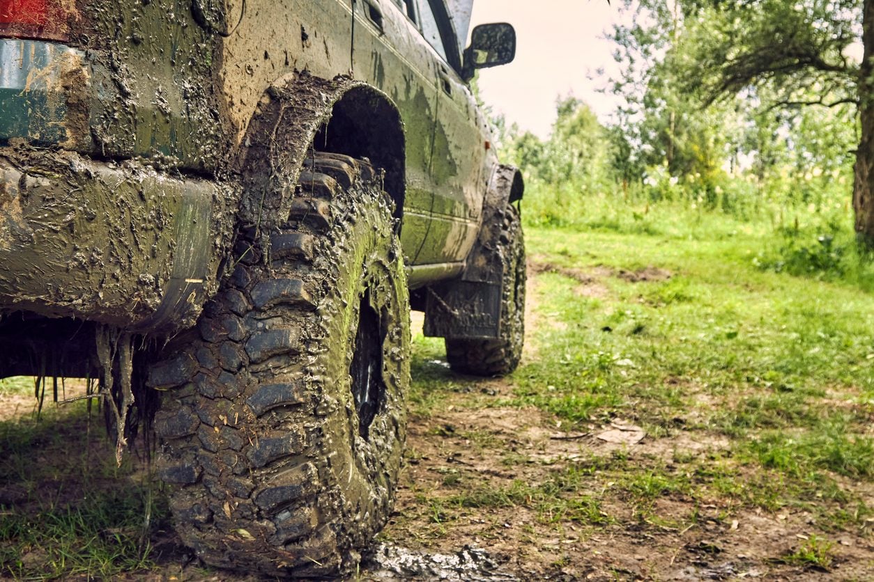Mud covered four wheel drive vehicle after off road driving