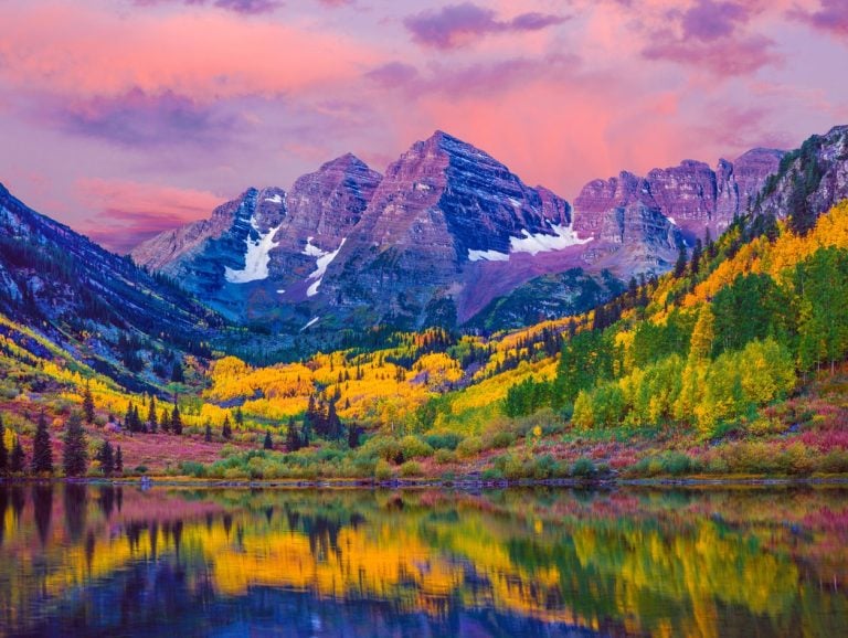 Maroon Bells peaks above autumn aspens in Colorado