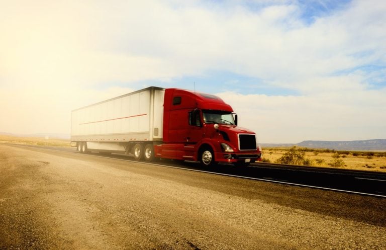 Tractor trailer on a California highway at golden hour