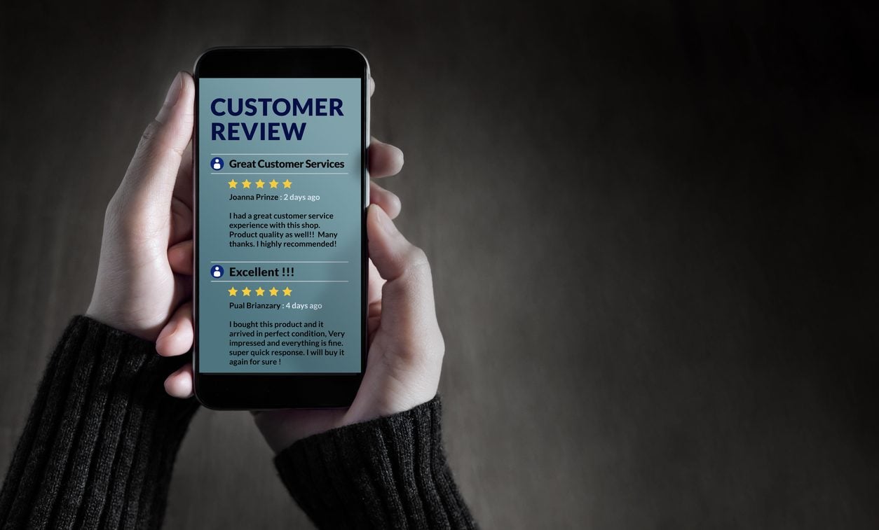 Person reading customer reviews and star ratings on a smartphone