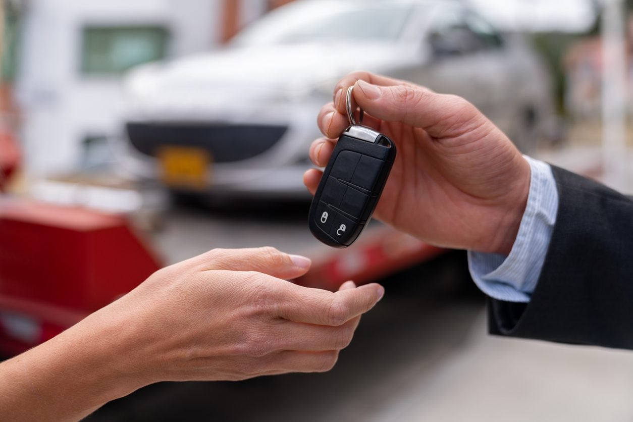 Key fob being handed to a new owner