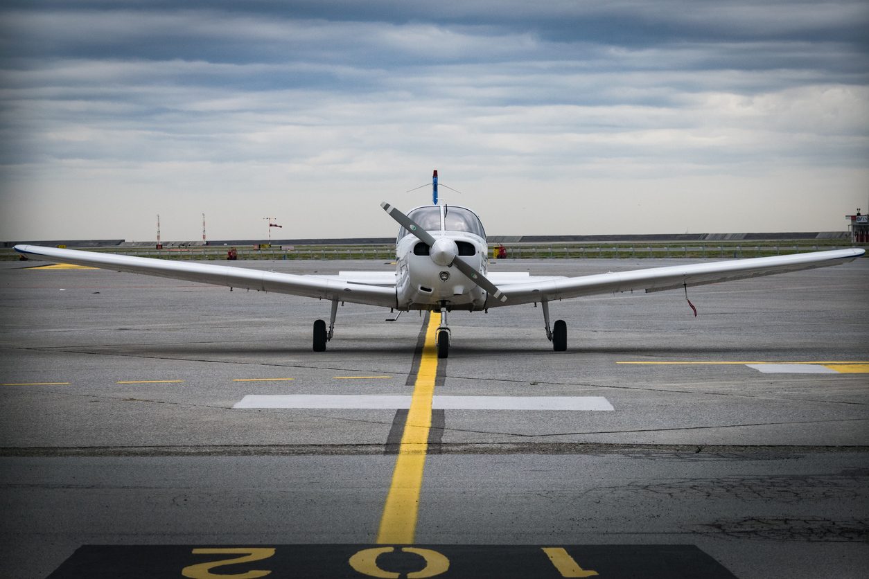 Light aircraft with a nose propeller on a runway