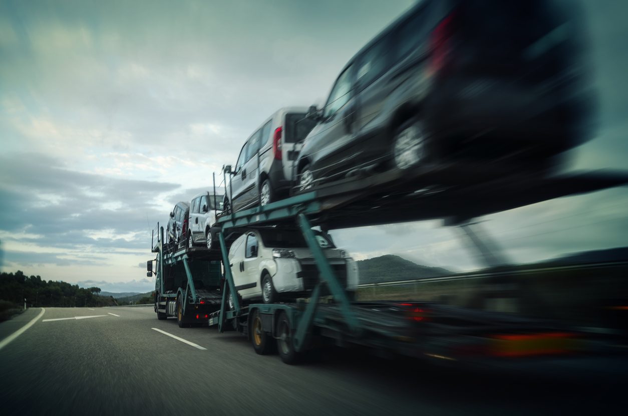 Loaded car hauler running a highway