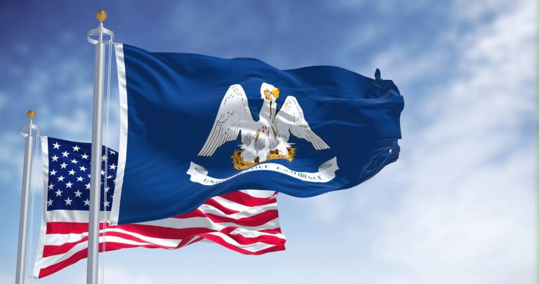 United States and Louisiana state flags flying together