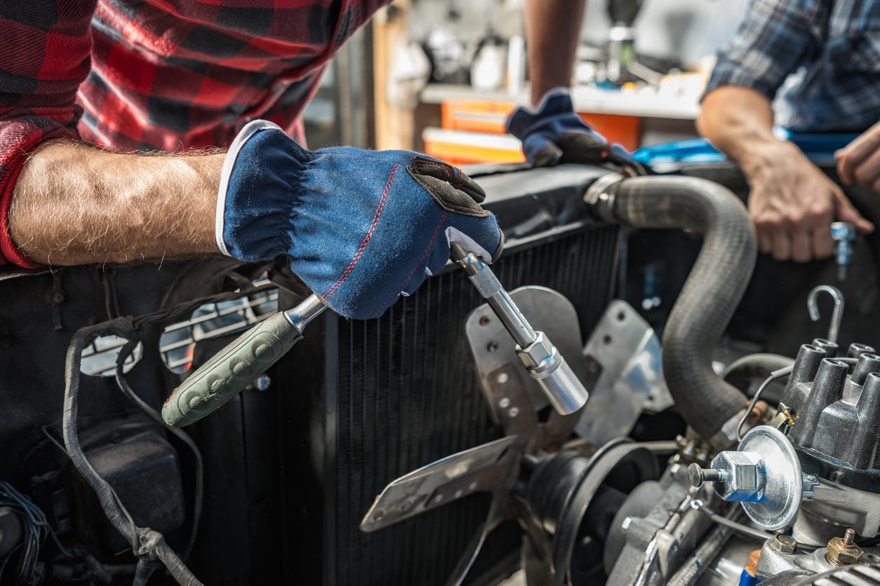 Mechanic working on a car engine in a workshop