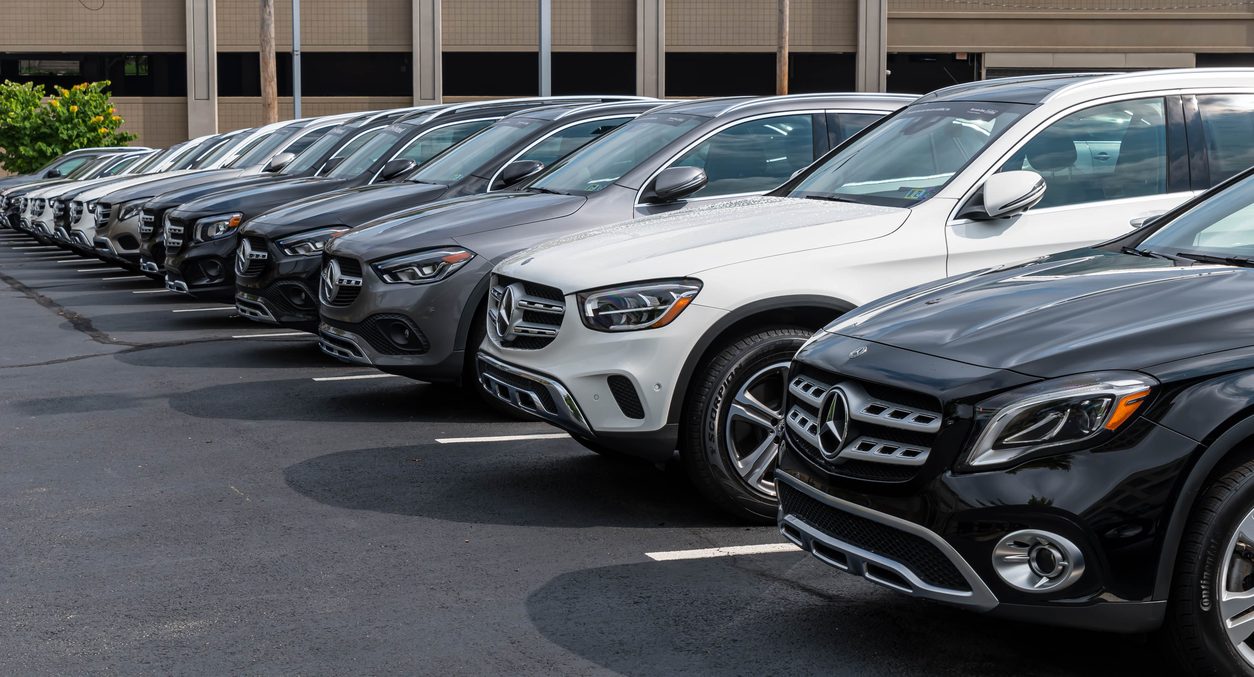 Line of Mercedes-Benz vehicles at a dealership