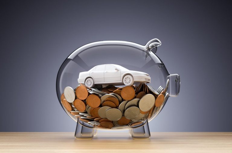 Model car in a glass savings jar with coins