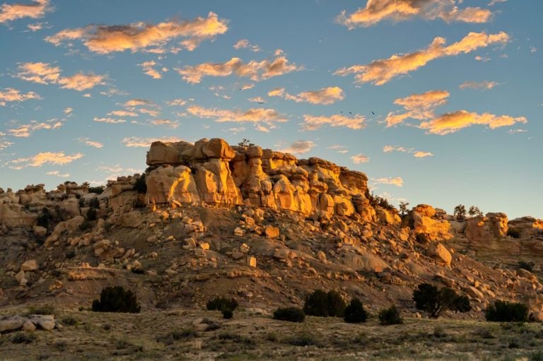 Rock formation and high desert scrub in New Mexico at sunset