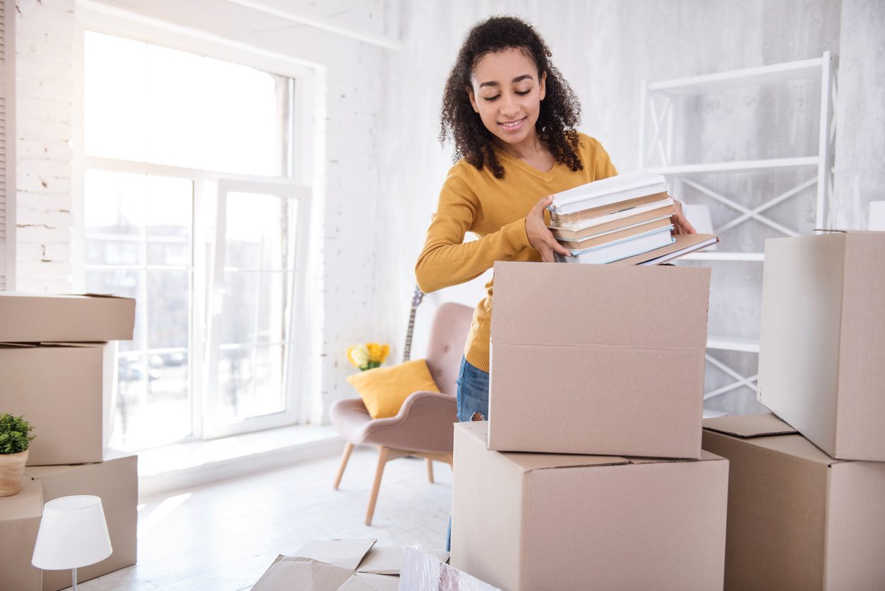Packing books into moving boxes before a relocation